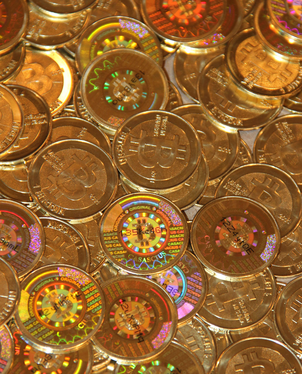 Casascius coins — physical bitcoins from 2011. Hidden in the hologram of each one is a private key to real BTC. Ironic? More like proof that we still picture a new kind of money as the old one.